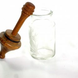 honey dipper in engraved glass jar