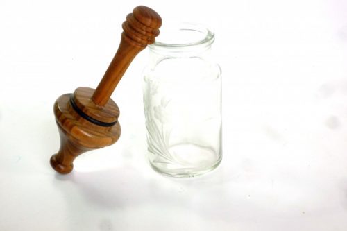 honey dipper in engraved glass jar